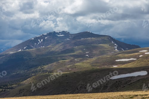 Preview: Mountain peak with afternoon clouds and dramatic lighting