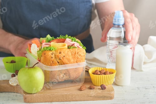 Preview: Healthy food for school lunch concept. Care father making school lunch. Sandwich with healthy bread,