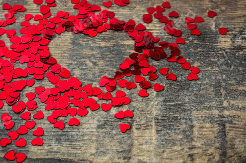Preview: Red hearts forming a larger heart shape on rustic wooden background