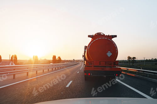 Preview: Truck driving on highway road at sunrise