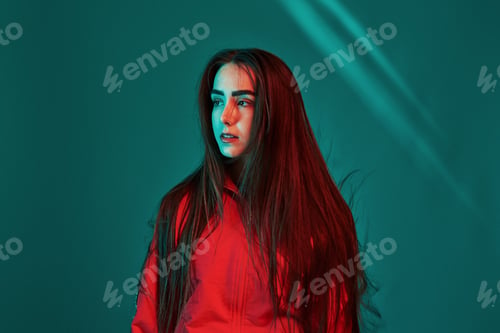 Preview: Teen in the studio indoors with neon light. Portrait of beautiful young girl