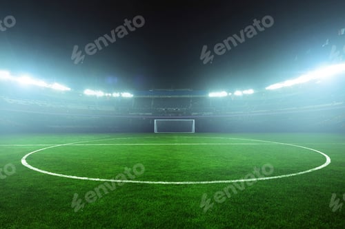 Preview: Brightly lit football stadium at night with green grass field and empty stands