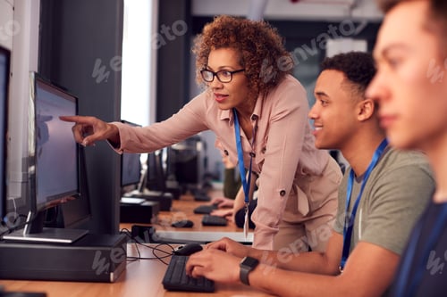 Preview: Group Of College Students With Tutor Studying Computer Design Sitting At Monitors In Classroom