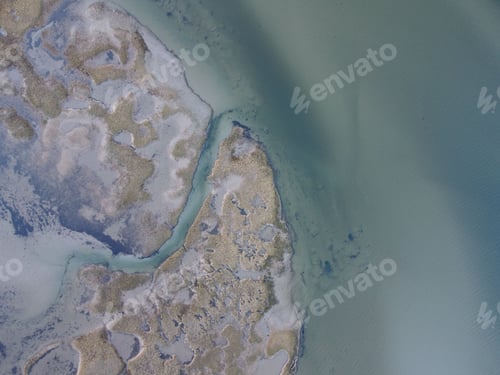 Preview: Aerial view of coastal tidal flats and clear water.
