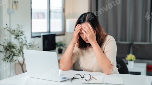 Preview: Woman experiencing stress and headache from working remotely