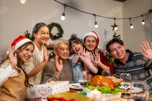 Preview: Asian family taking a photo while celebrate Christmas party together.