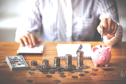 Preview: businessman holding a coin in a piggy bank On a table with sunlight. Money Saving Ideas for Financia