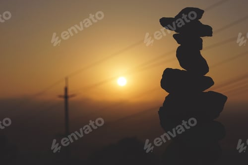 Silhouette of balanced rocks during a vibrant sunrise