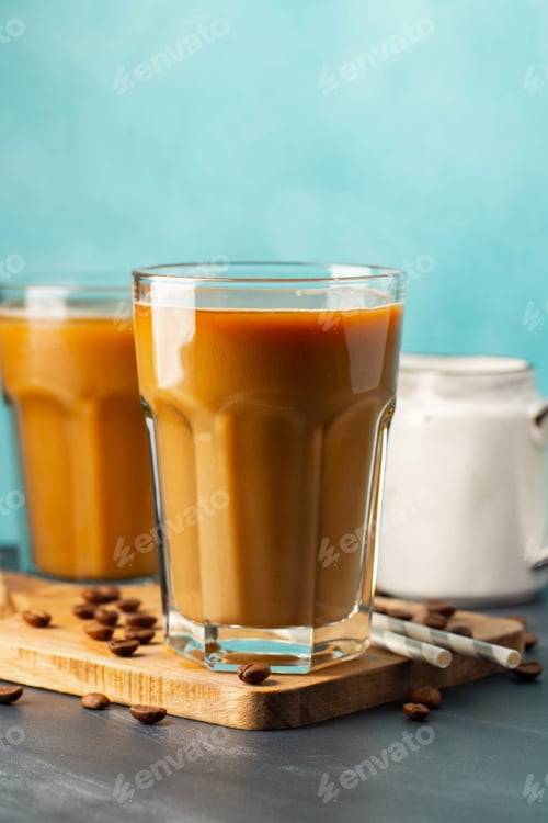 Preview: Ice coffee in a tall glass with cream poured over.