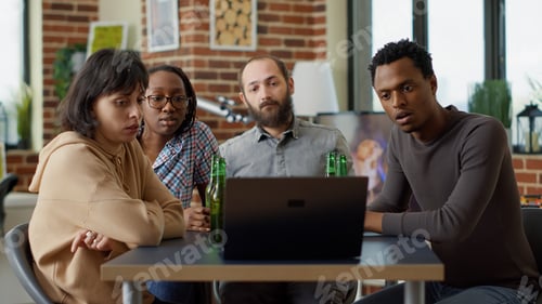 Preview: Millennial people watching online video on laptop together