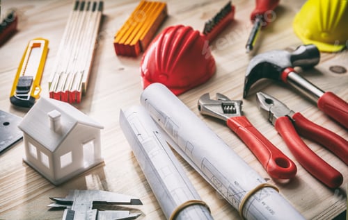 Preview: Tools, hardhats and project plans on wooden desk