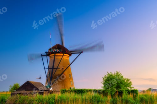 Preview: Kinderdijk National Park in the Netherlands. Windmills at dusk. A natural landscape in a historic lo