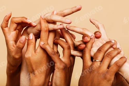 Preview: Close up shot of a group of hands reaching up and holding on to each other