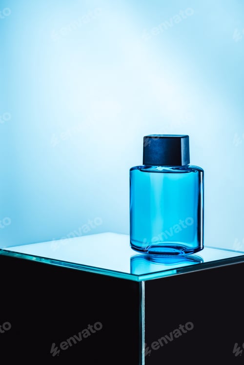 Preview: mens perfume in blue spray bottle, on blue