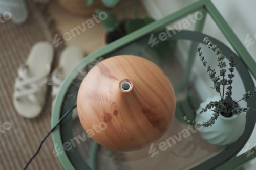 Preview: Distant view of a wooden diffuser on a table at home