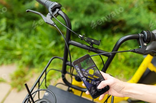 Preview: girl takes a photo of the details of a bicycle. ecological transport