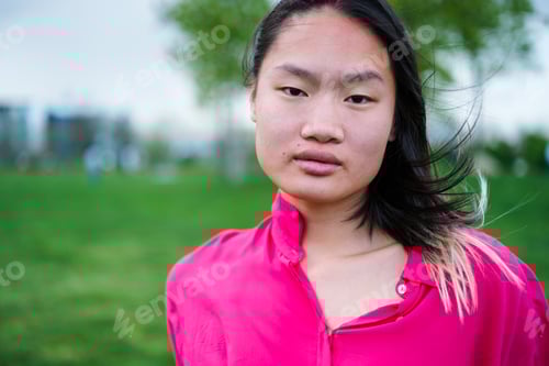 Preview: Lifestyle portrait of a young woman with oriental features in the park