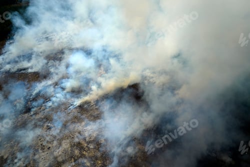 Preview: View from above of dense smoke from woodland and field on fire rising up polluting air.