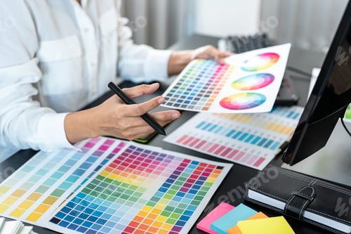 Preview: Young creative graphic designer working on color selection and drawing on graphics tablet