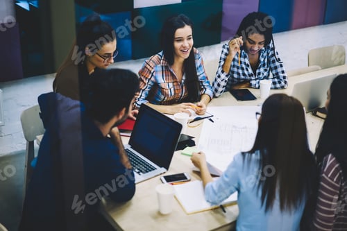 Preview: Group of coworkers brainstorming in workspace