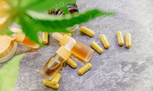 Preview: Flat lay of CBD and HHC oil capsules and balm, Medical marijuana products with Cannabis plant