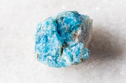 Preview: sample of raw apatite rock on white marble
