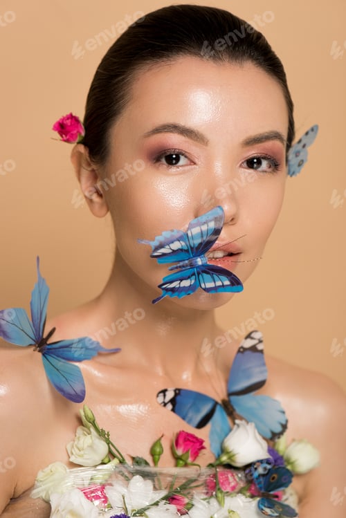 Preview: attractive tender naked asian girl in flowers with butterflies on face isolated on beige