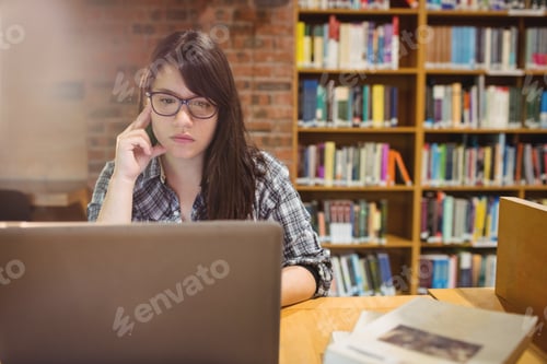 Preview: Thoughtful female student using laptop