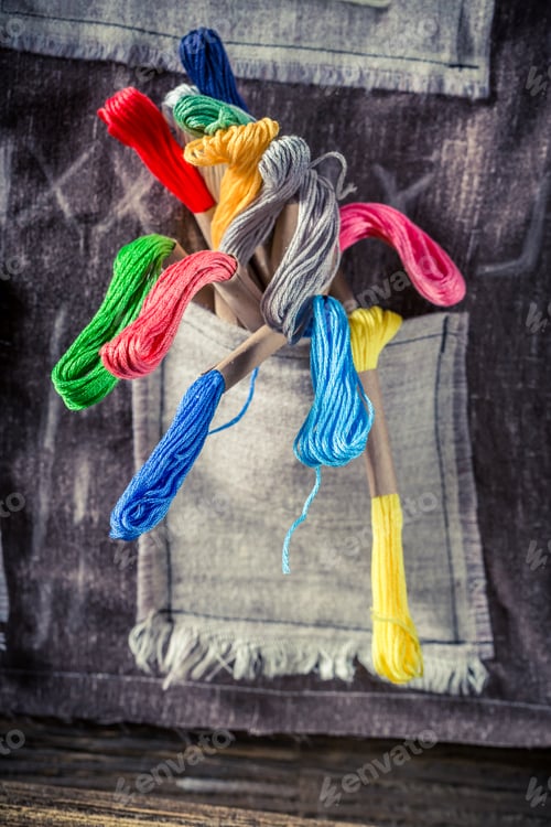Preview: Closeup of colored threads in tailor workshop