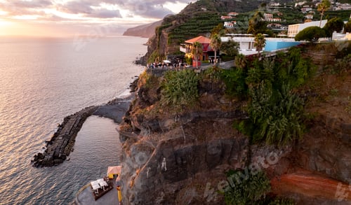 Preview: Picturesque scenery of houses on cliff near sea