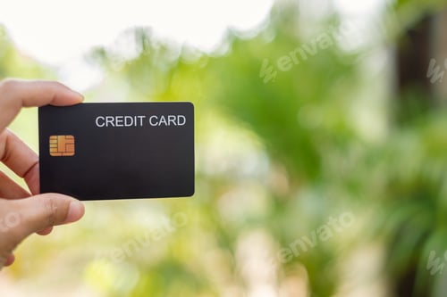 Preview: Credit Card. hand holding credit card with green nature background and concept online shopping