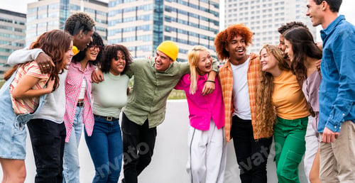 Preview: Happy playful multiethnic group of young friends bonding outdoors