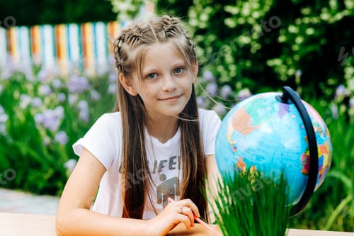 Preview: Smiling Girl with Globe Outdoors Learning and Education