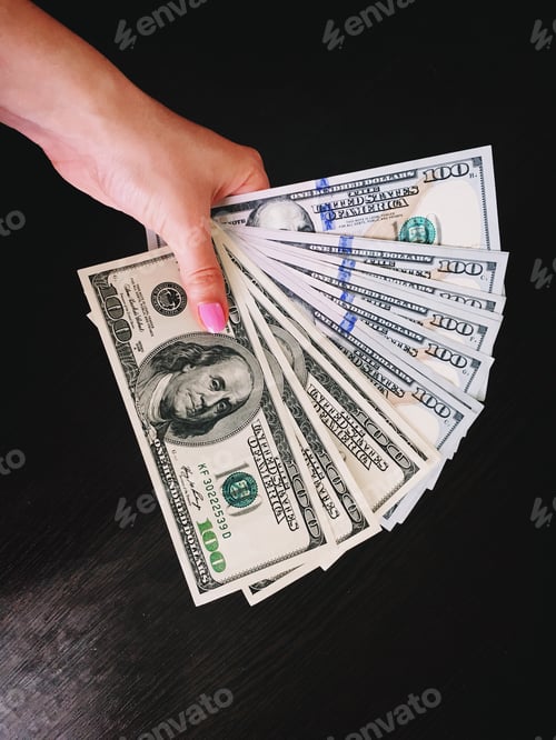 Preview: Female hand. Dollars in woman's hand