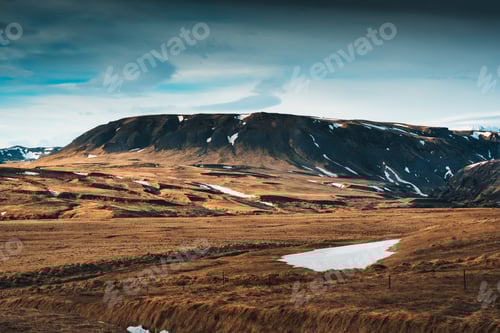 Preview: Barren rugged mountain with blue sky in remote wilderness at Iceland