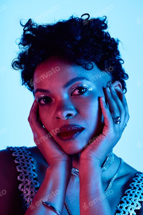 Preview: Captivating expression of a stylish african american woman under blue lighting