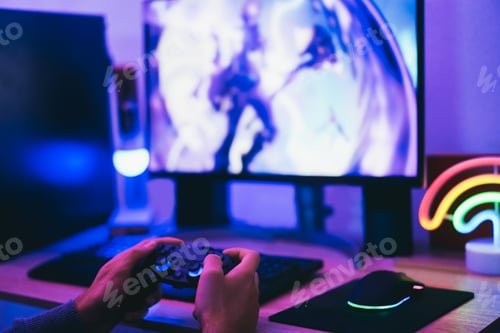 Preview: Boy gamer playing strategy game online - Focus on right hand holding joystick controller
