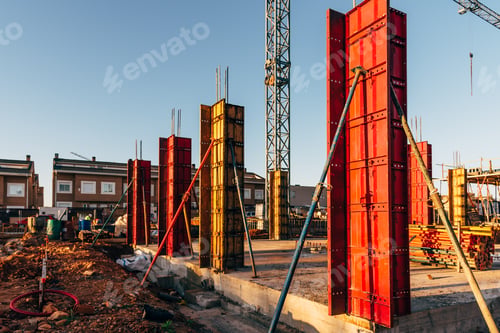 Preview: Construction site with steel formworks and reinforcing bars for pillars ready for concrete