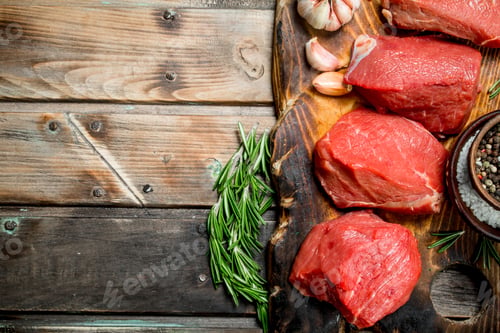 Preview: Raw meat. Sliced pieces of beef with spices and herbs.
