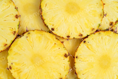 Preview: Yellow background of sliced pineapple. Top view