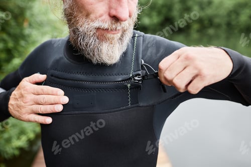 Preview: Close Up of Bearded Man Putting on Wetsuit