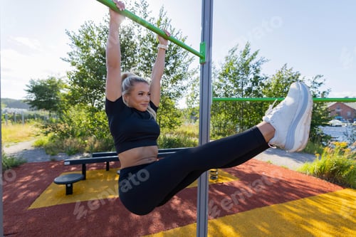 Preview: Woman performing fitness exercise outdoors at a vibrant park workout station
