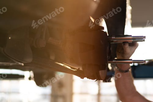 Preview: Car service technician checking car wishbones and control arms