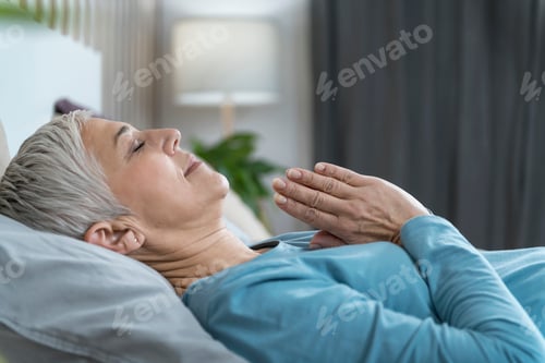 Preview: Meditation Before Sleeping. Beautiful Mature Woman Lying in Bed and Meditating with her Eyes Closed