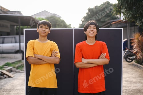 Preview: Confident Two Young Asian Sportsman Standing While Crossed Keeping Arm