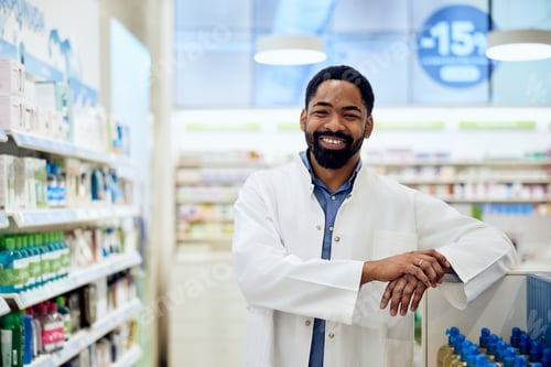 Preview: Smiling Confident Pharmacist Standing in a Modern Store with Shelves of Products