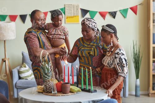 Preview: African family of four celebrating Kwanzaa at home