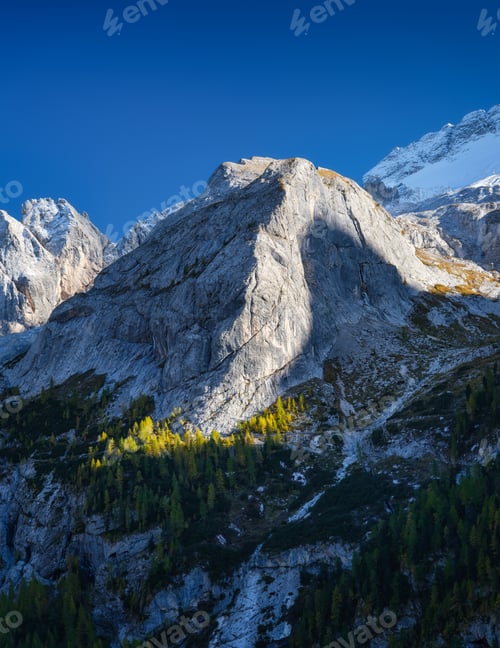 Preview: High sharp rocks and forest. Mountain valley before sunset. Natural landscape.