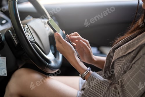 Preview: Woman using a smartphone while driving danger.