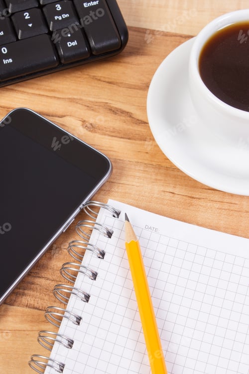 Preview: Mobile phone with notepad for writing notes and cup of coffee